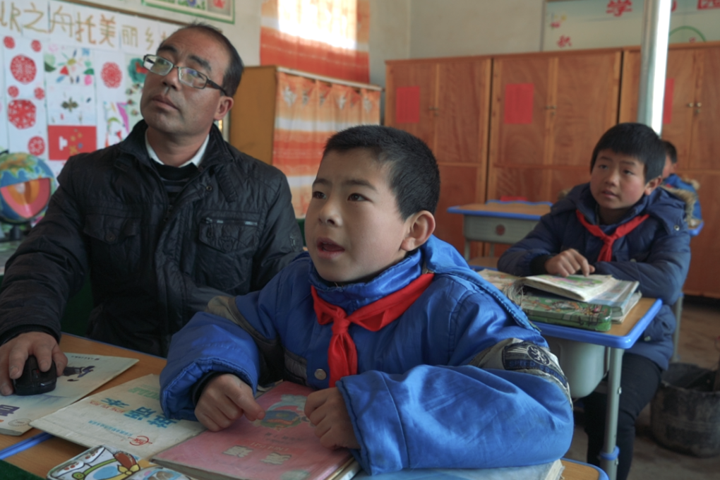 Headmaster Feng Ping and his three students in their classroom at Lumacha primary school, Dingxi, Gansu province. Photo: SCMP