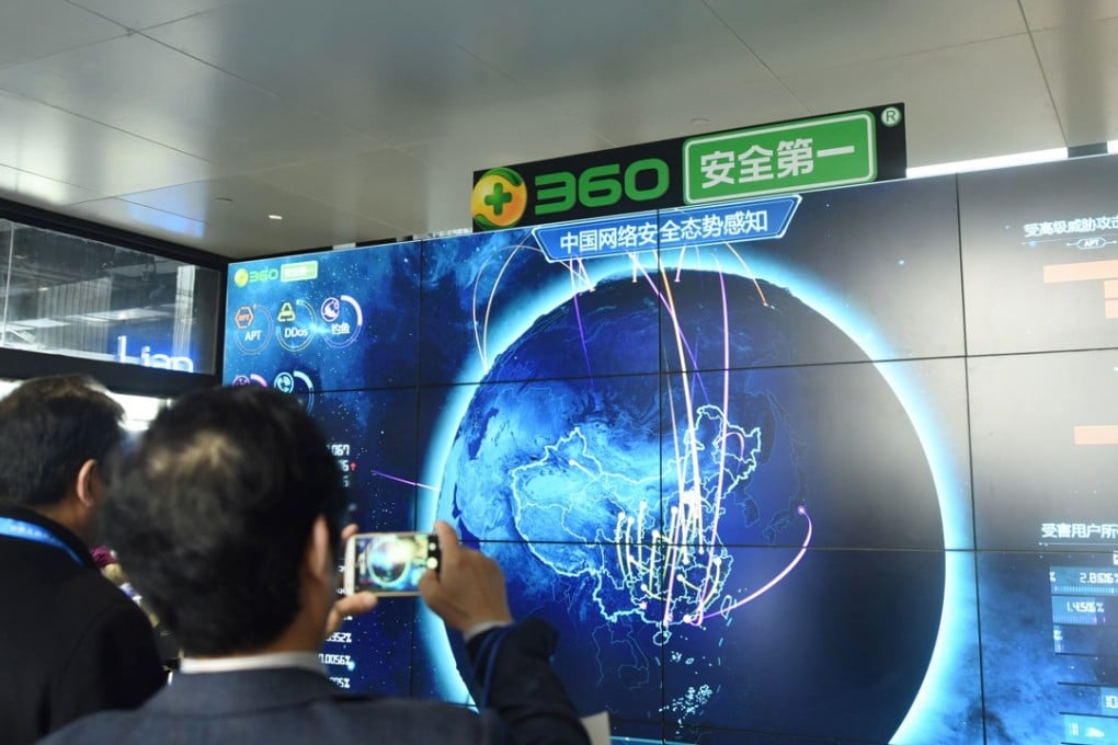 A man takes pictures of internet security data displayed on a screen at the Qihoo booth during the World Internet Conference in Wuzhen, China, last December. Photo: AFP