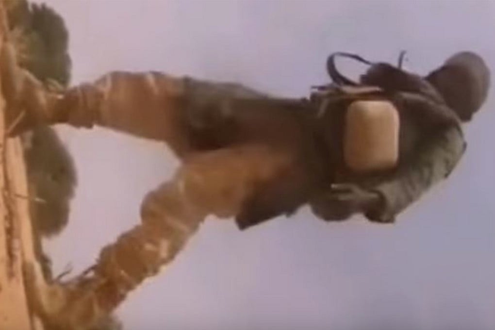 An Islamic State fighter walks past the helmet camera of a US soldier, killed moments before in an ambush in Niger last October. Photo: YouTube