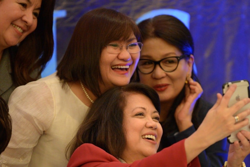 Philippine's Chief Justice Maria Lourdes Sereno (seated) poses for a selfie with municipal judges, during the annual convention of the country's judges, in Manila. Photo: AFP