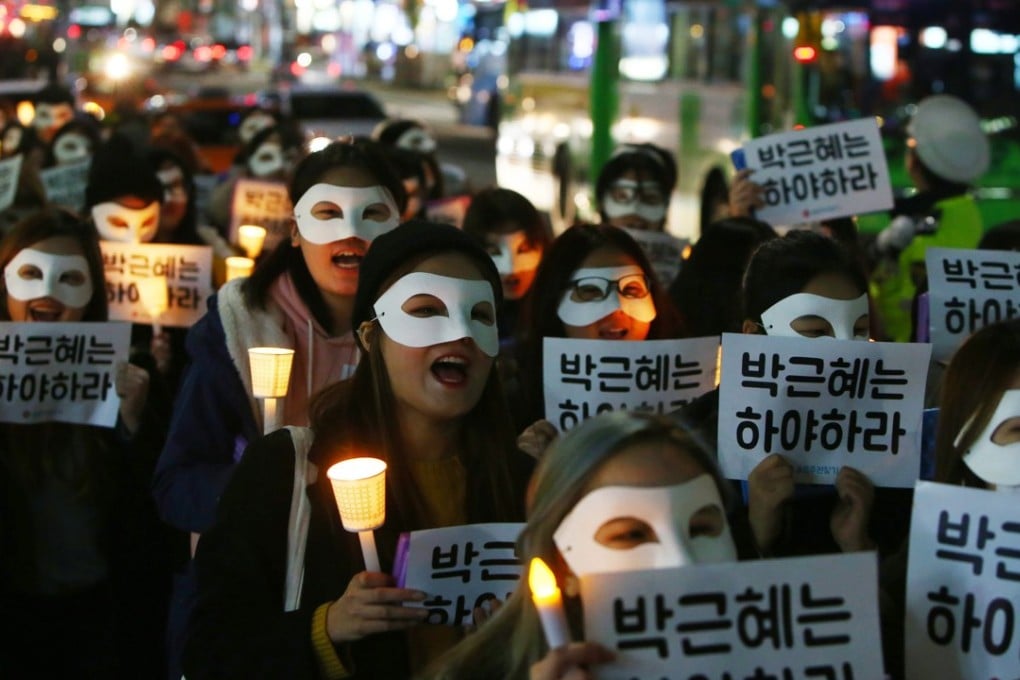 South Korean university students march with candles during a protest against Park Geun-hye in 2016. File photo: EPA