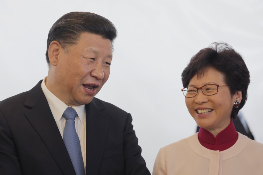 Chinese president Xi Jinping shares a light moment with Chief Executive Carrie Lam during a visit to the site of high speed cross-border rail terminus in West Kowloon district, Hong Kong. Photo: EPA