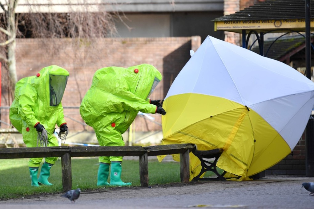 Members of the emergency services in hazard suits put a tent over the bench where a Russian former double agent and his daughter were found critically ill. Photo: AFP