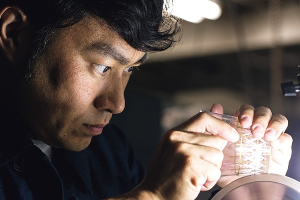 Third-generation glass cutter Toru Horiguchi at work on a design in Funabori, Tokyo.