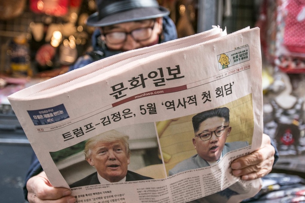 A man reads a copy of the Munhwa Ilbo newspaper featuring news of US President Donald Trump and North Korean leader Kim Jong-un on the front page in Seoul. Photo: Bloomberg