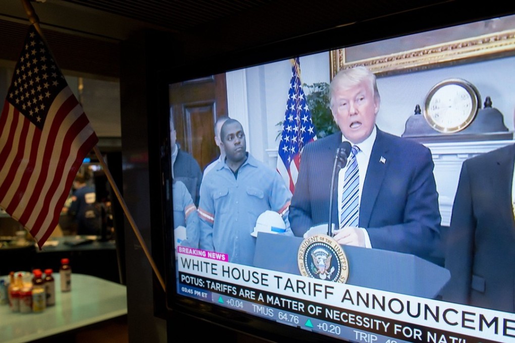 US President Donald Trump speaks on television as traders work on the floor at the closing bell of the Dow Industrial Average at the New York Stock Exchange. Photo: AFP
