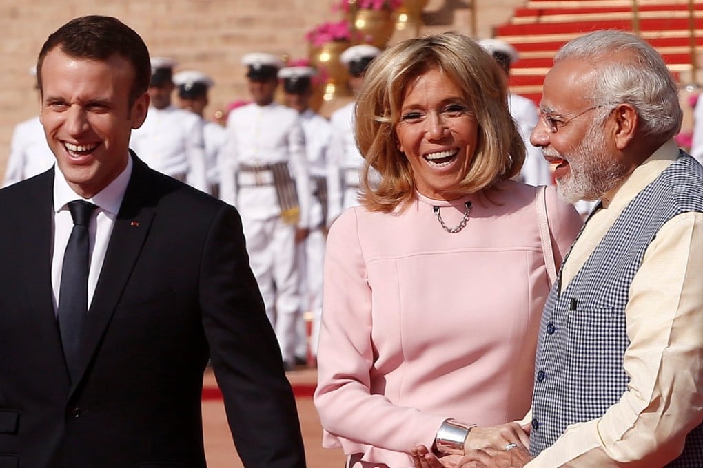 French President Emmanuel Macron and his wife Brigitte Macron laugh with India's Prime Minister Narendra Modi during the French leader’s ceremonial reception. Photo: Reuters