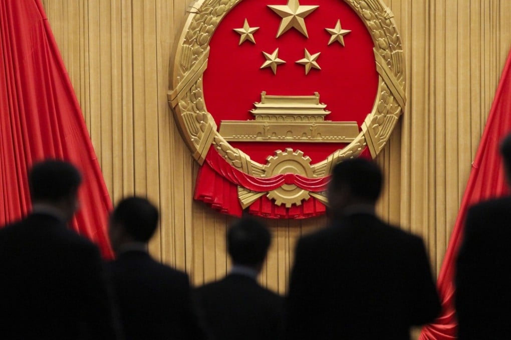 NPC delegates enter the meeting hall to cast their votes on amendments to the constitution on Sunday. Photo: Simon Song