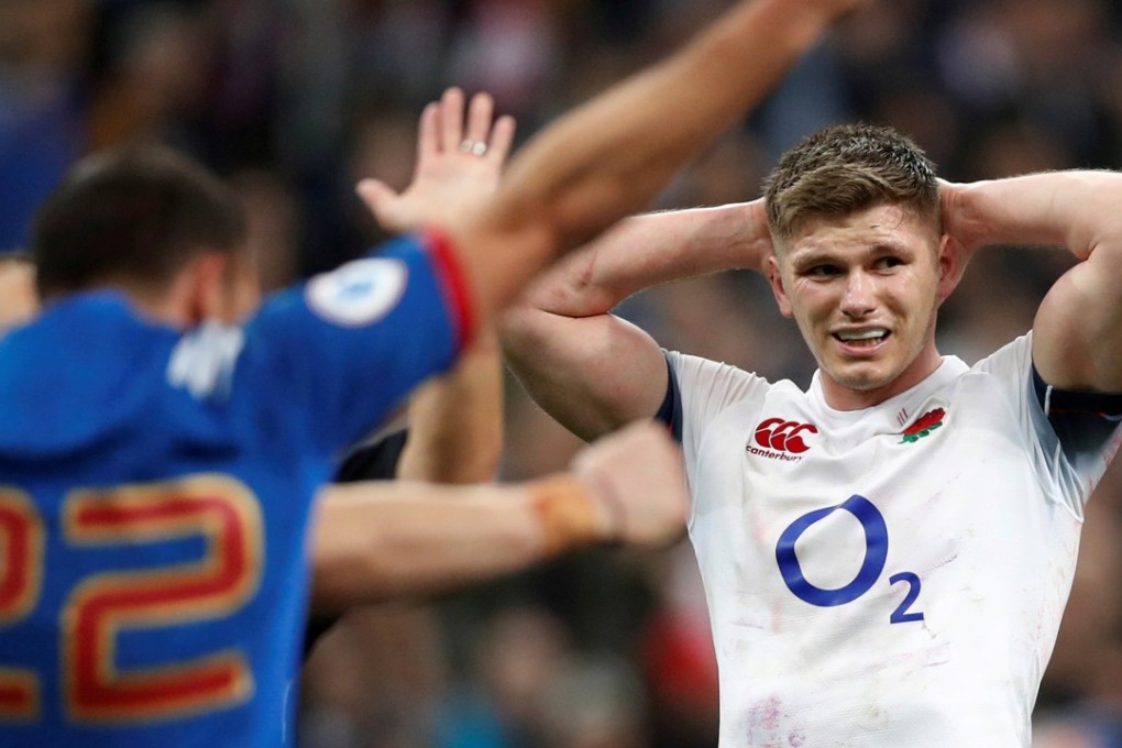 England’s Owen Farrell looks dejected as France celebrate victory after the match. Photo: Reuters