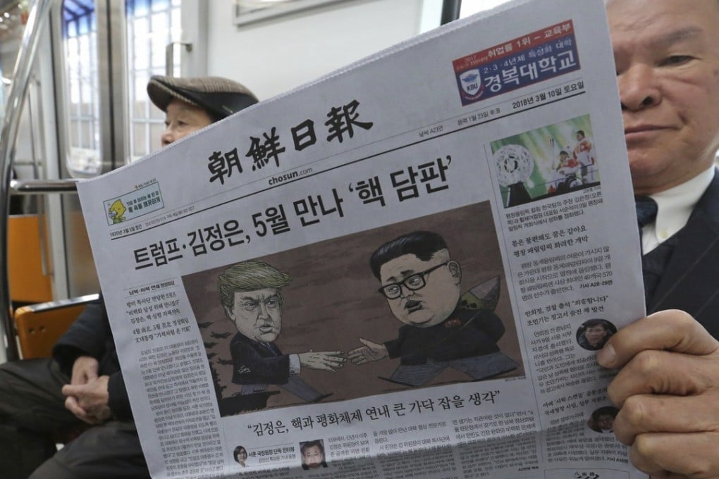 A South Korean train passenger reads a newspaper with headline of a planned summit meeting between North Korean leader Kim Jong-un and US President Donald Trump. Photo: AP