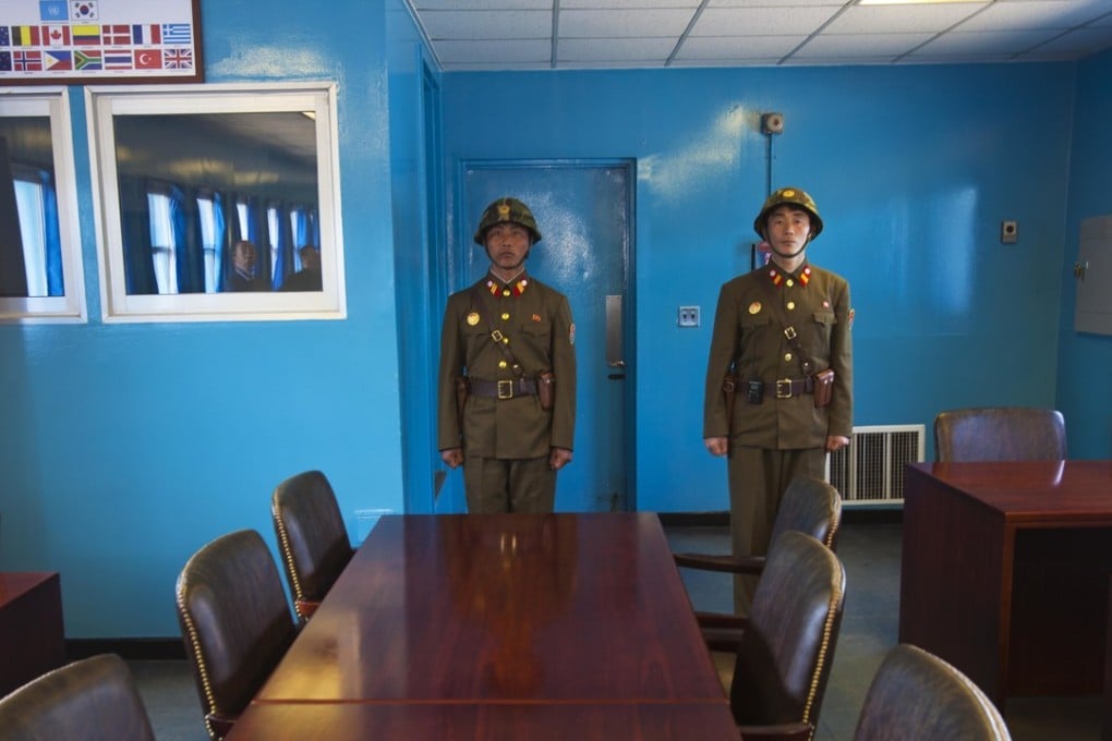 North Korean soldiers stand guard inside the building shared by North and South Korea at the truce village of Panmunjom at the demilitarised zone (DMZ) which separates the two Koreas. File photo: AP