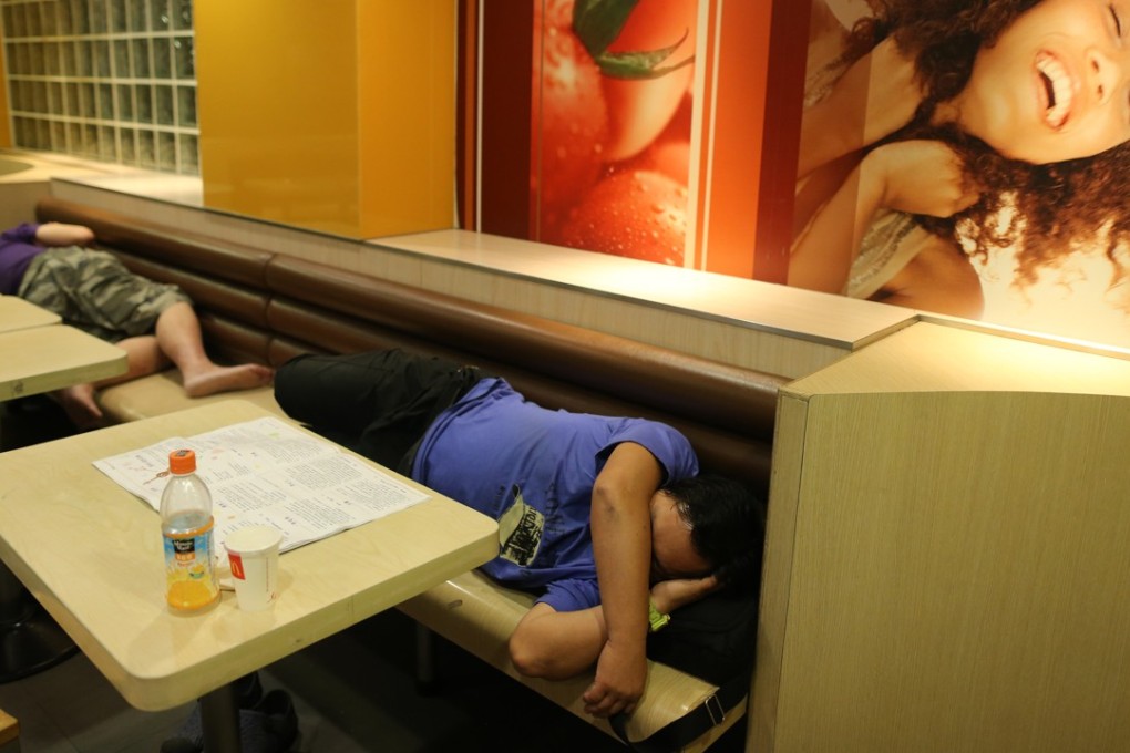 Homeless people asleep at a McDonald’s. Photo: Dickson Lee