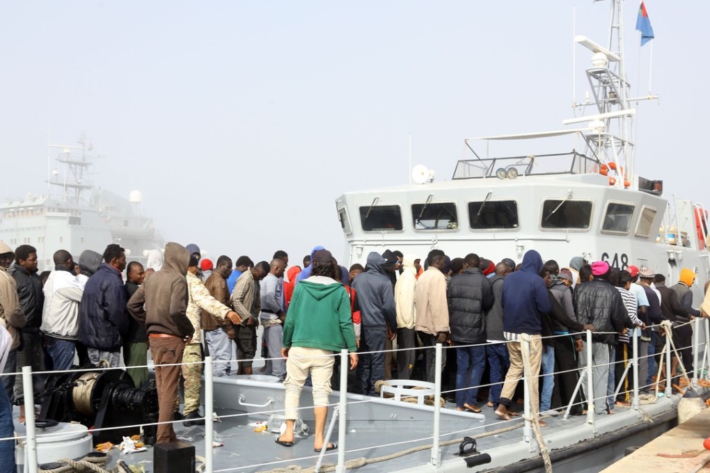 Illegal immigrants arrive at a navy base from a Libyan coast guard vessel in Tripoli, Libya. Photo: Xinhua