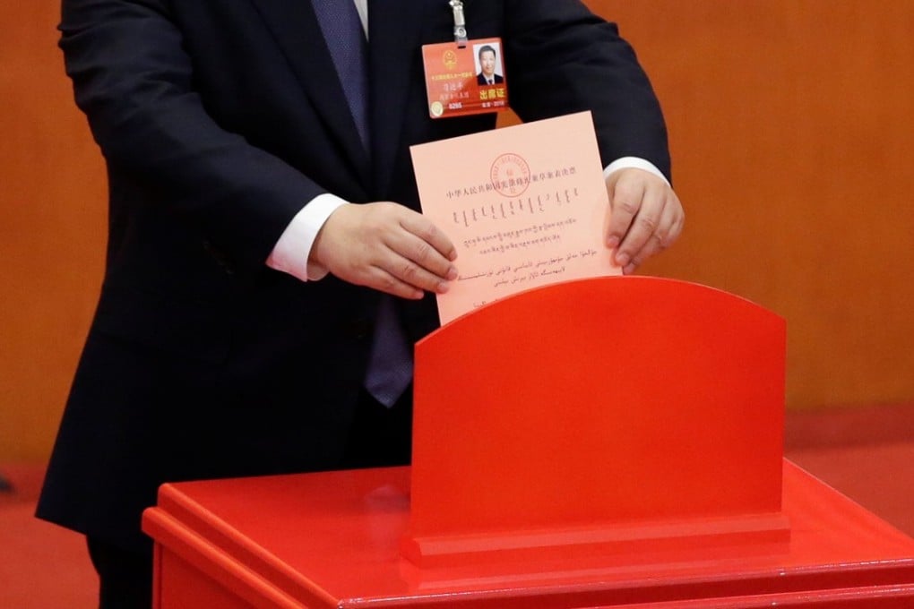 Chinese President Xi Jinping drops his ballot during a vote on a constitutional amendment lifting presidential term limits, at the third plenary session of the National People's Congress at the Great Hall of the People in Beijing. Photo: Reuters