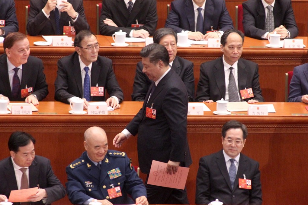 China’s National People’s Congress delegates voted overwhelmingly in favour of a change to the country’s constitution that enables Xi Jinping (standing) to remain president beyond 2023. Photo: Simon Song