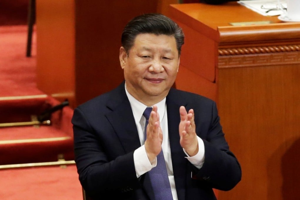 President Xi Jinping applauds at the Great Hall of the People in Beijing after NPC deputies passed a constitutional amendment on Sunday removing the term limit on the presidency, among other changes. Photo: Reuters