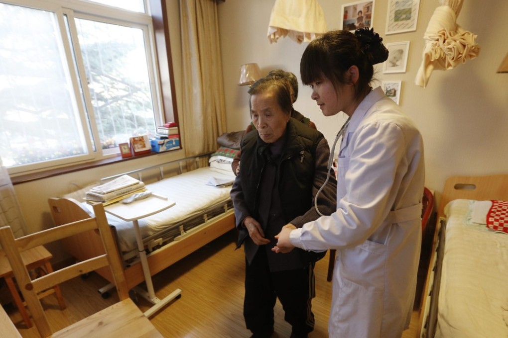 A nurse and patient at a retirement facility in Beijing. China’s society is ageing at a rapid pace, opening up markets for care services. Photo; EPA