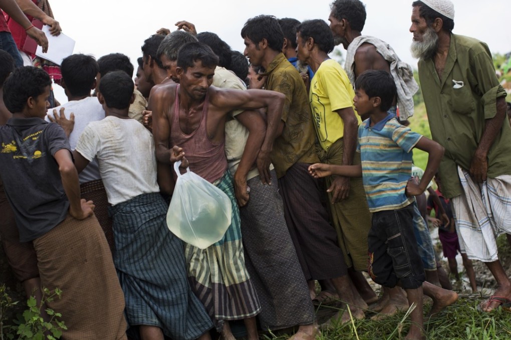 Rohingya Muslims living in no-man's-land collect water donated by Bangladesh Red Crescent members, near Cox's Bazar's Tombru area. File photo: AP