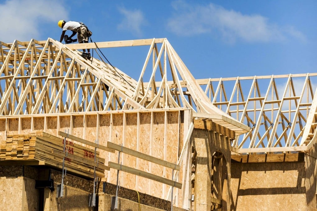 A builder works on the roof of a new home under construction in a suburb north of Toronto in Vaughan, Canada. Photo: Reuters