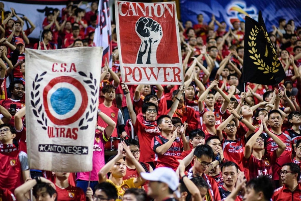 Fans of Chinese soccer team Guangzhou Evergrande hold up banners during its AFC Champions League match with Hong Kong's Eastern at Mong Kok Stadium in April last year. Photo: AFP