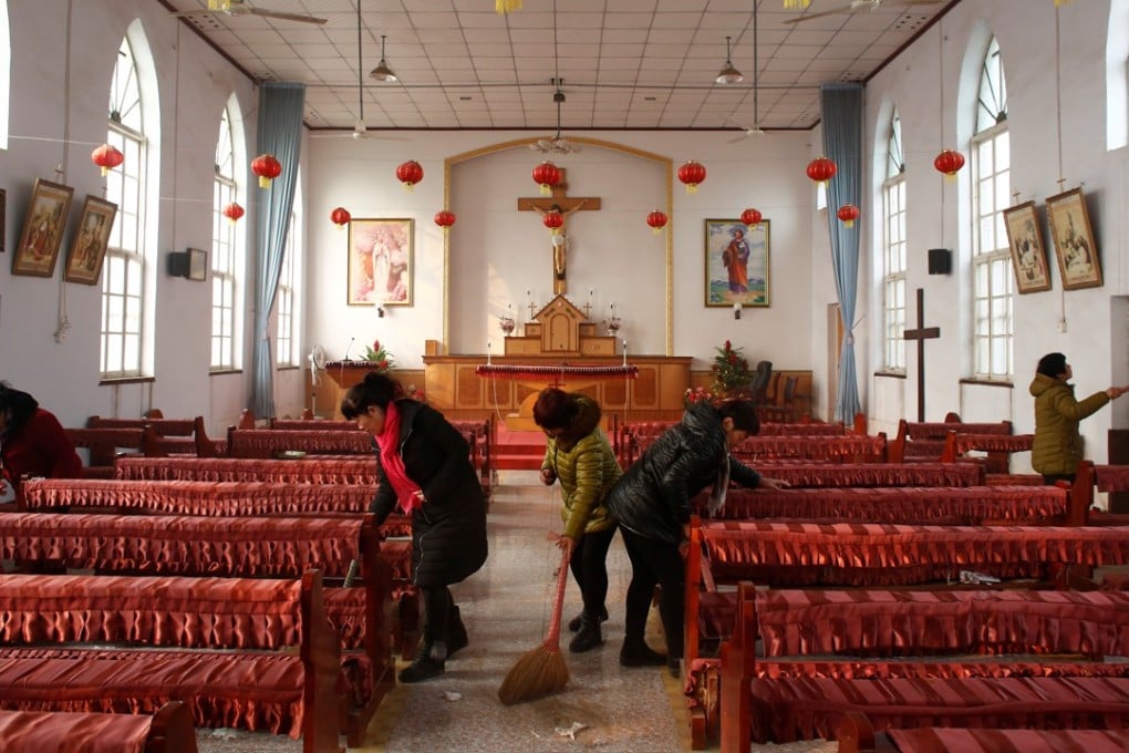 Members of the congregation clean an unofficial Catholic church in Hebei province, after a Sunday service in December 2016. Photo: Reuters