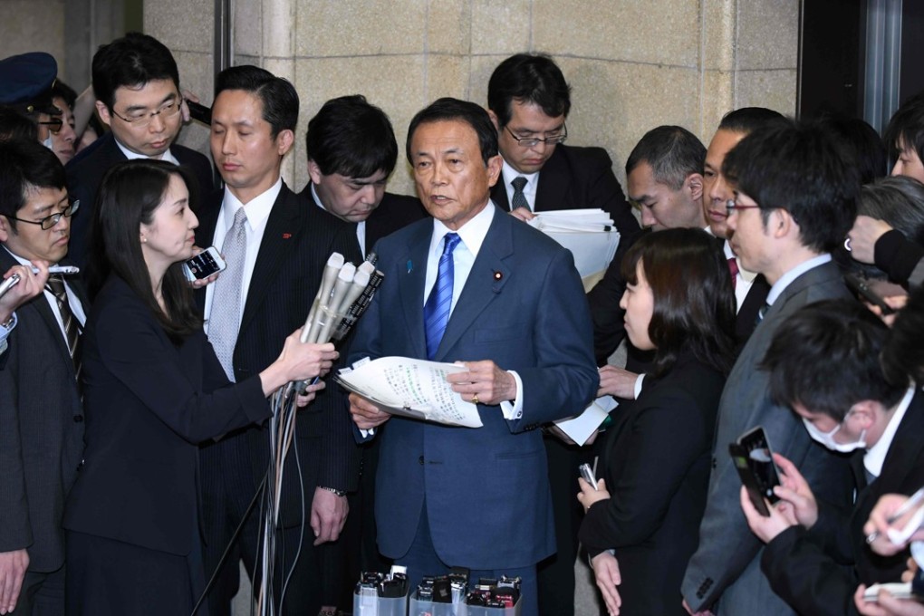Japan's Finance Minister Taro Aso (centre) speaks during a press briefing at the finance ministry in Tokyo on Monday. Photo: Agence France-Presse
