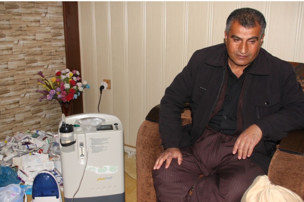 Iraqi Kurd Kamal Jalal, 47, sits next to an oxygen machine which helps him breath, at his home in the Kurdish town of Halabja on March 12. As a teenager Kamal Jalal saw two of his sisters killed when dictator Saddam Hussein's forces launched a gas attack on the town. Photo: Agence France-Presse