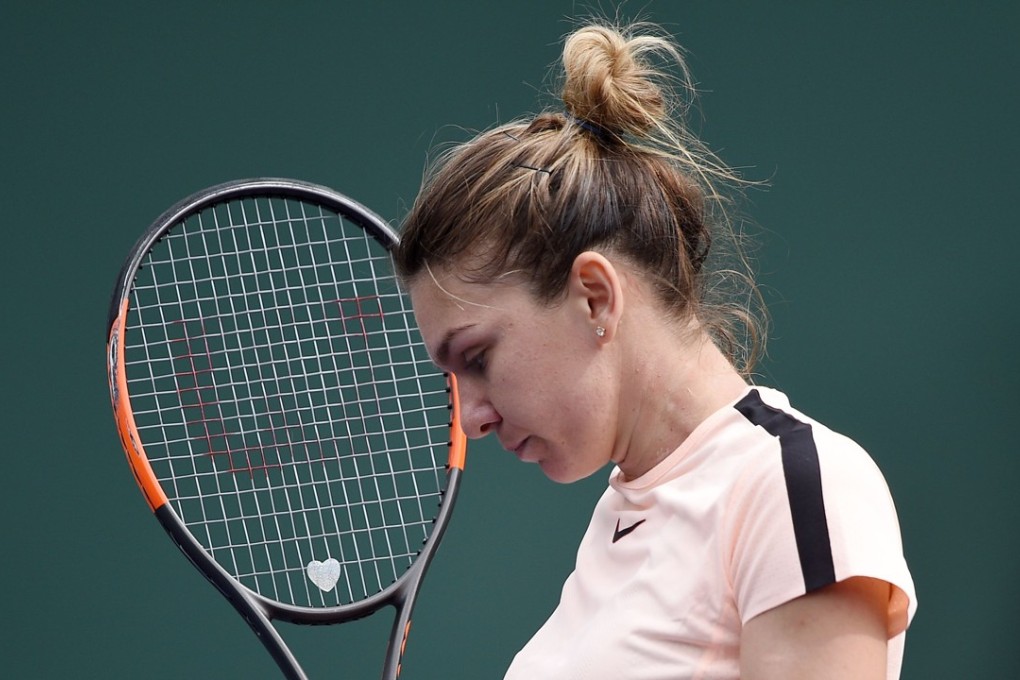 Simona Halep of Romania celebrates after winning a game against Wang Qiang of China at Indian Wells. Photos: AFP