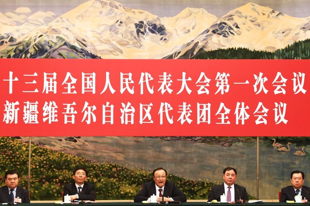 Shohrat Zakir (centre) told the Xinjiang delegation meeting there was a significant improvement in “social harmony” last year. Photo: AFP