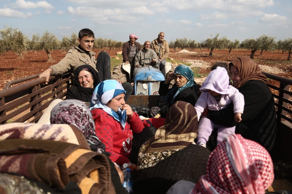 Syrian civilians flee Afrin after Turkey said its army and allied rebels surrounded the Kurdish city in northern Syria on Tuesday. Photo: Agence France-Presse