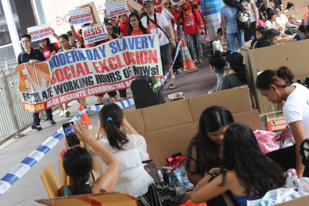 Members of the Asian Migrants’ Coordinating Body campaigning for a wage increase march past helpers congregating in Central on their day off. Photo: Felix Wong