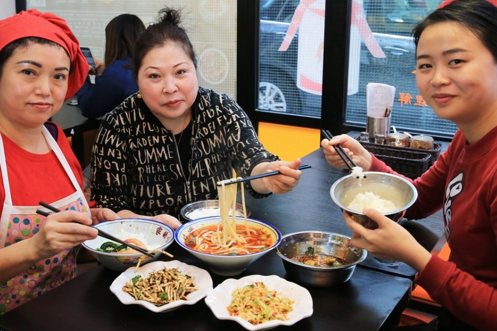 From left: Li Wenju, Guo Daoqun (head chef and owner), and Zhou Shunli show off their Guizhou specialities at Wan Wan Xiang in Causeway Bay. Photo: Dickson Lee
