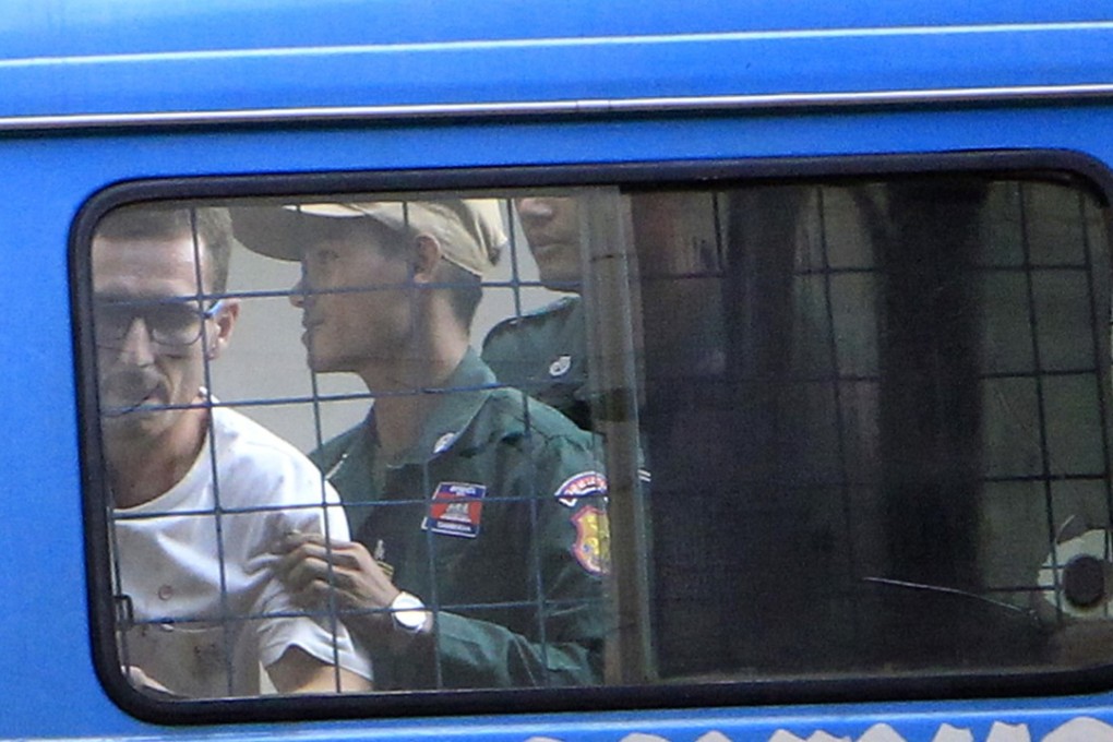 British citizen Daniel Jones is escorted by a prison guard to Siem Reap court in Cambodia. Photo: AP