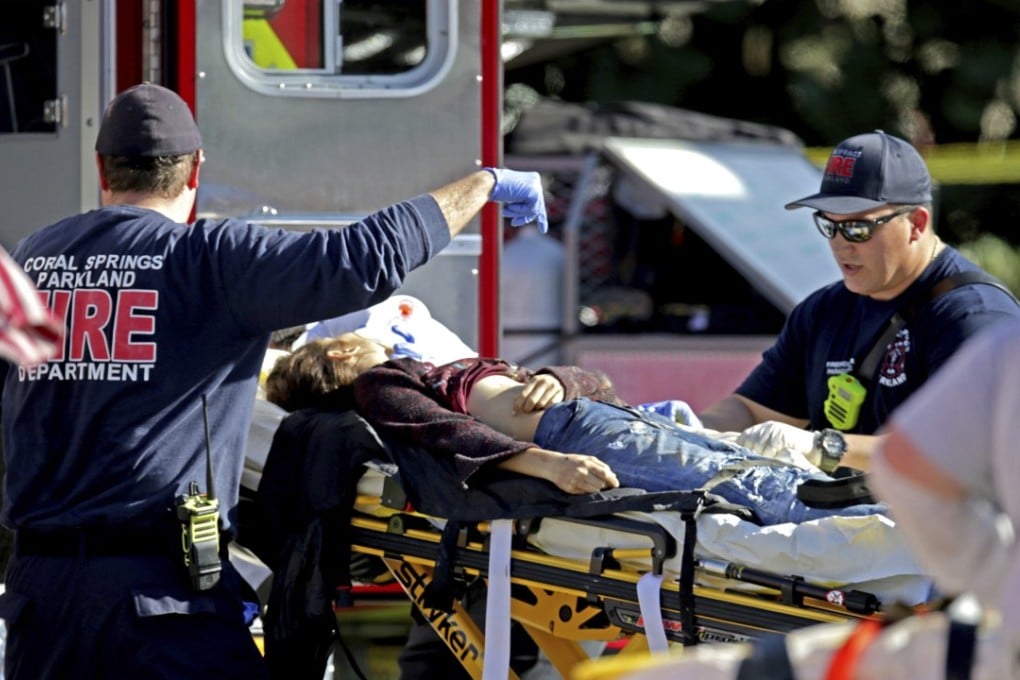 Medical personnel tend to a victim following a shooting at Marjory Stoneman Douglas High School in Parkland, Florida, on February 14. Newly released transcripts revealed the full horror of the shooting on Wednesday. File photo: South Florida Sun-Sentinel via AP