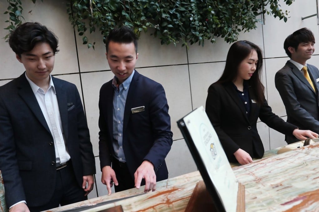 Interns and staff at the Hotel Icon in Tsim Sha Tsui. The students bring creativity to the job, colleagues say, and guests appreciate their eagerness. Photo: Jonathan Wong
