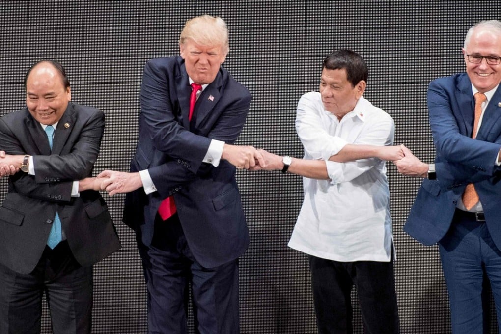Vietnam's Prime Minister Nguyen Xhan Phuc, US President Donald Trump, Philippine President Rodrigo Duterte and Australia Prime Minister Malcolm Turnbull join hands for a family photo during the opening ceremony of the 31st Asean Summit in Manila in 2017. File photo: AFP