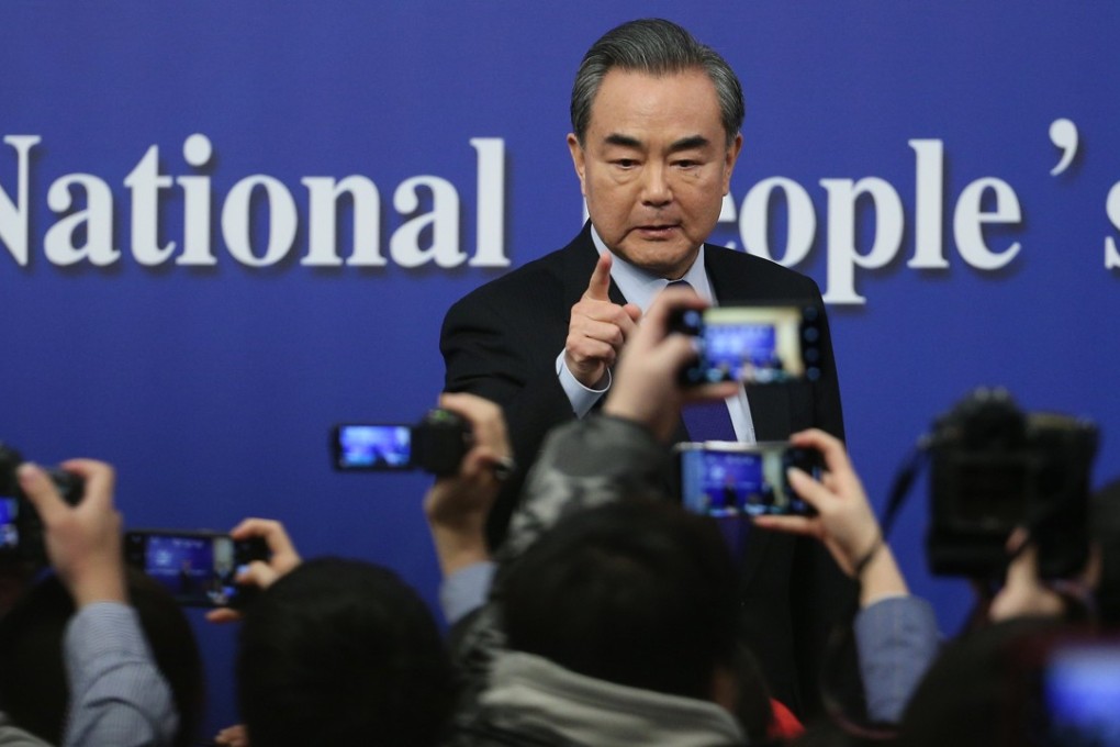 Chinese Foreign Minister Wang Yi gestures to reporters as he concludes a press conference on the sidelines of China's National People's Congress (NPC) in Beijing, March 8, 2018. Photo: EPA