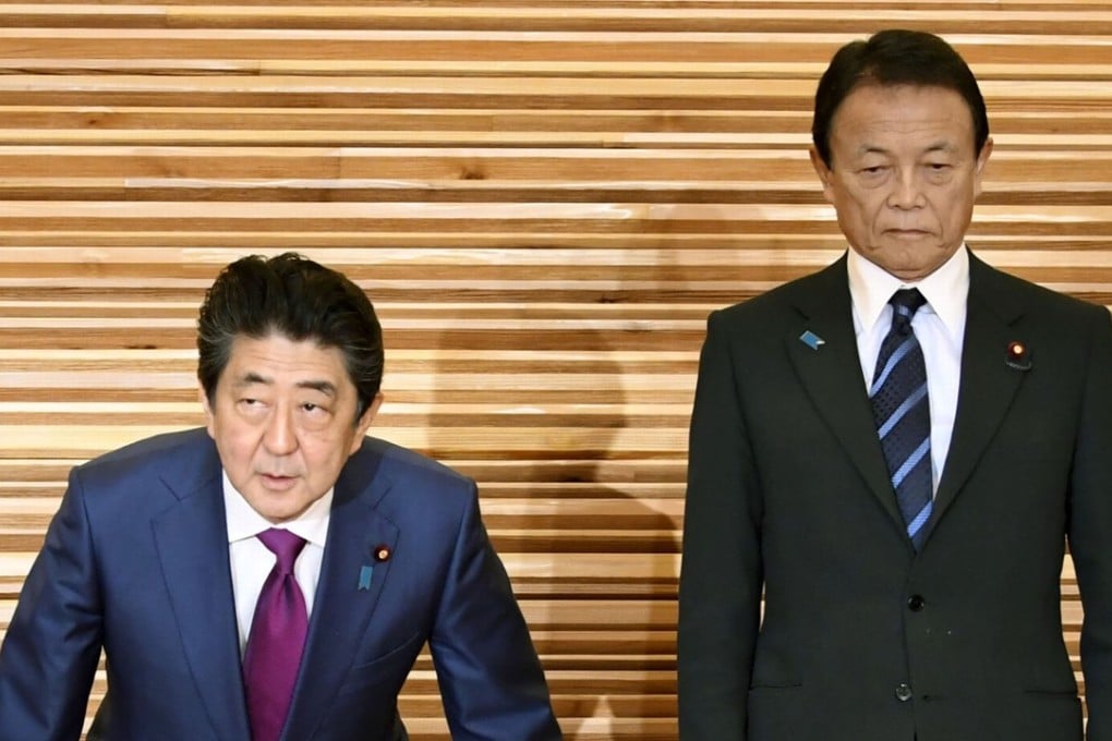 Japanese Prime Minister Shinzo Abe and Finance Minister Taro Aso at a cabinet meeting in Tokyo on March 16, 2018. Photo: Kyodo