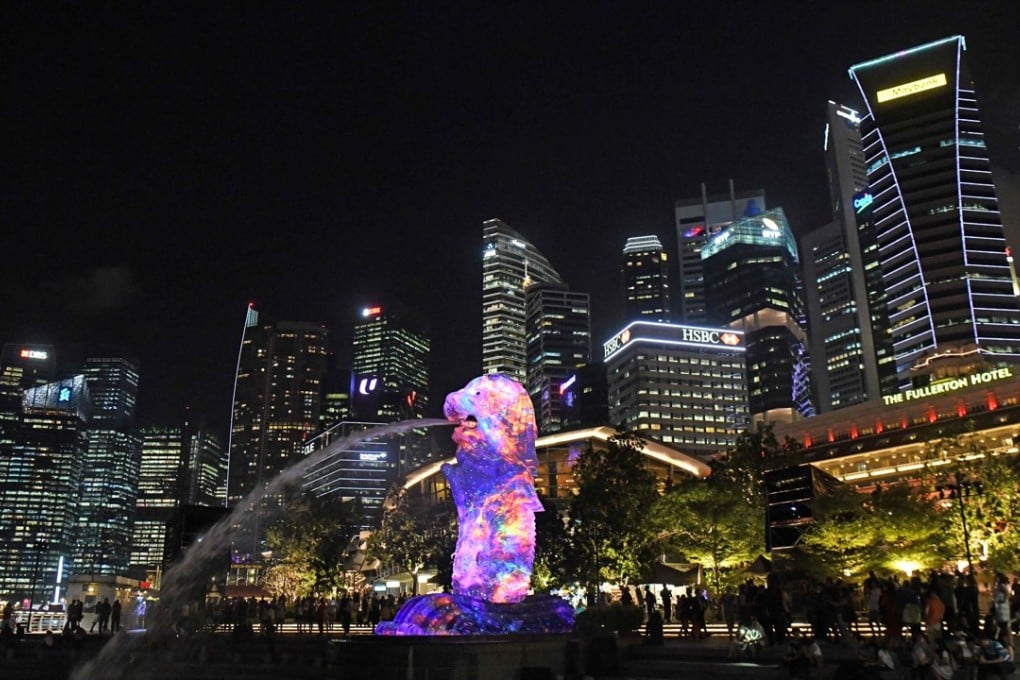 The Merlion statue lit up in front of the city skyline in Singapore. Photo: AFP