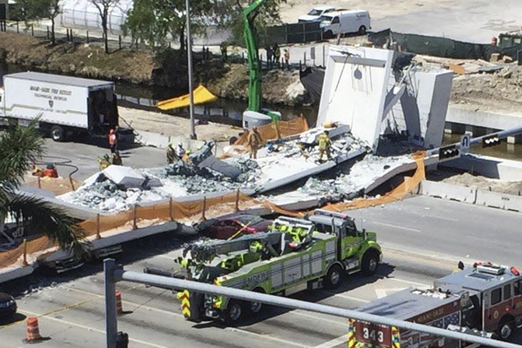 Emergency personnel respond to a collapsed pedestrian bridge at Florida International University on Thursday, March 15, 2018, in the Miami area. The brand-new pedestrian bridge collapsed onto a highway killing several people and crushing multiple vehicles. Photo: Miami Herald via AP