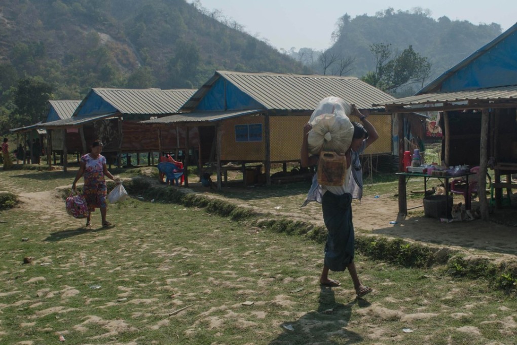 Rakhine villagers carrying their belongings in Koe Tan Kauk village in Myanmar's Rakhine State, where Rohingya homes once stood. Photo: AFP
