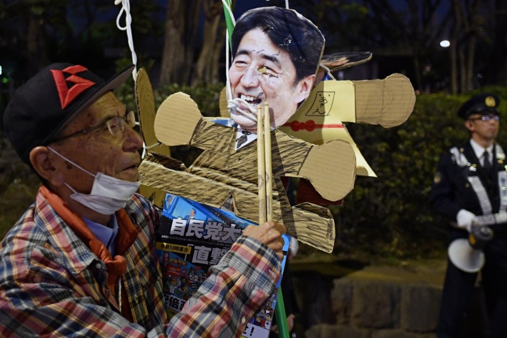 A protester at the National Diet in Tokyo demands the resignation of Japanese Prime Minister Shinzo Abe. Photo: EPA