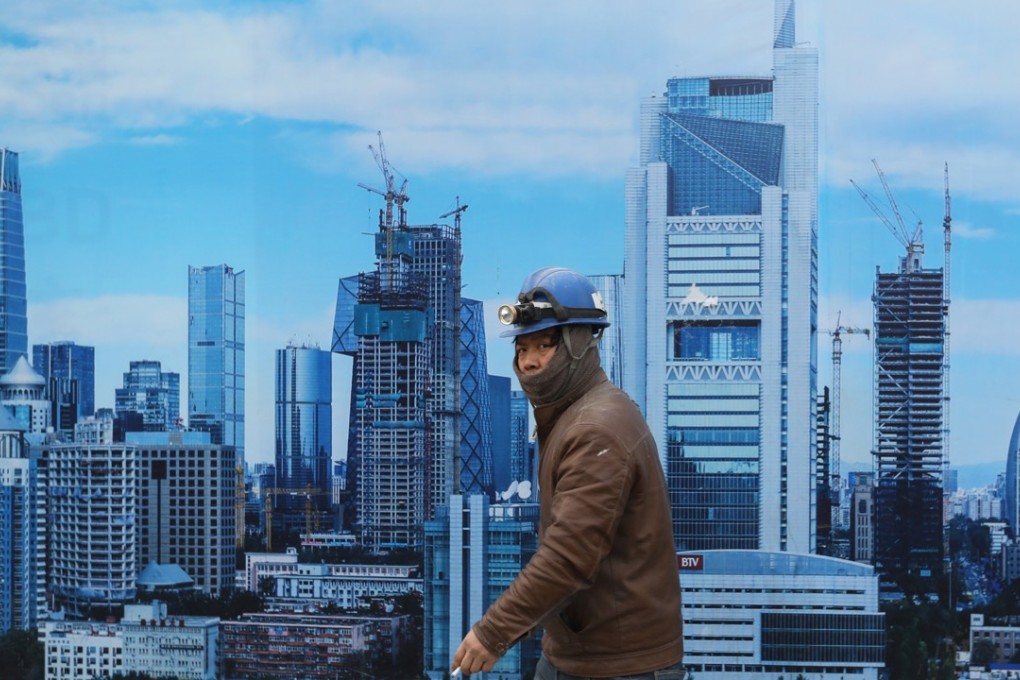 A Chinese migrant worker in Beijing’s central business district. Photo: EPA