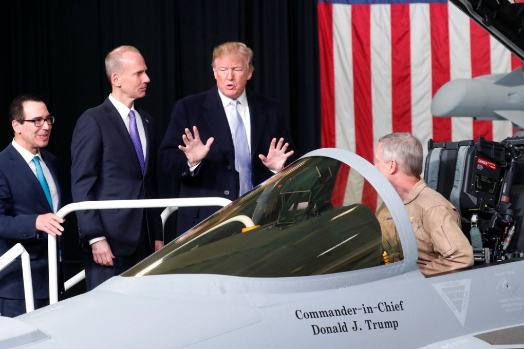 US President Donald Trump looks over an EA-18 Growler as he tours Boeing with Boeing Chairman and CEO Dennis Muilenburg (centre) and Treasury Secretary Steve Mnuchin (left) in St Louis, Missouri, on Wednesday. Photo: Reuters
