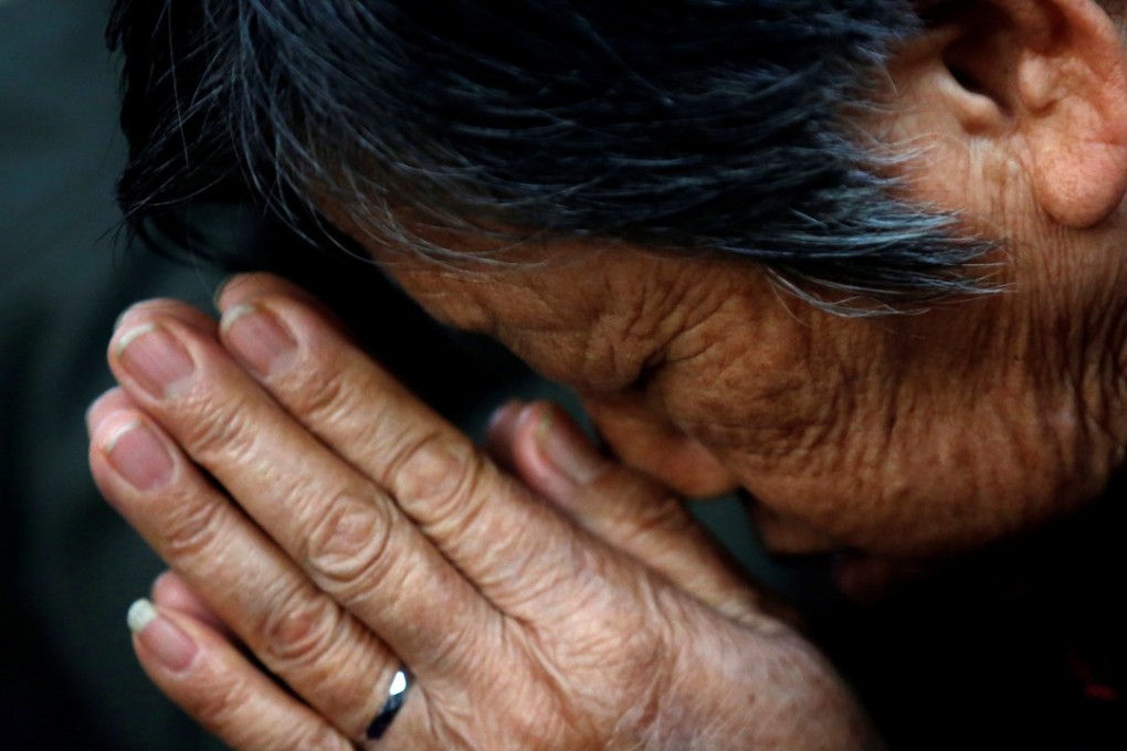 An underground Catholic churchgoer prays during a weekend mass in Tianjin. Photo: Reuters
