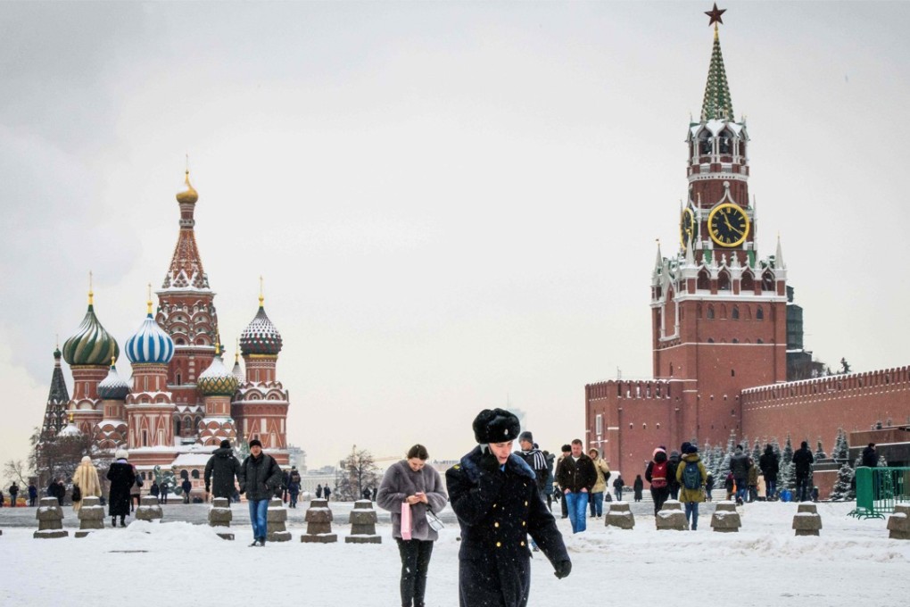 A serviceman walks in front of St. Basil's Cathedral and the Kremlin on Red Square in Moscow on Thursday. Russia has denied ever making the nerve agent reportedly used to poison an ex-spy in the UK. Photo: AFP