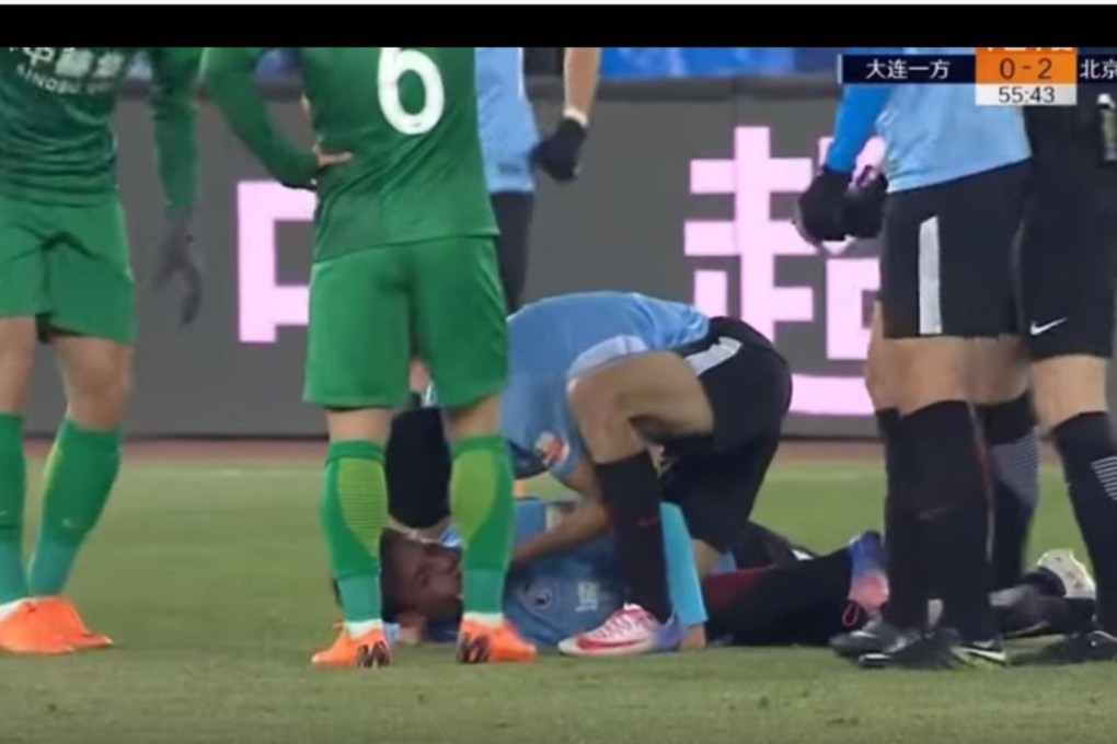 Yannick Carrasco clears the airway of stricken Dalian Yifang teammate Nico Gaitan.
