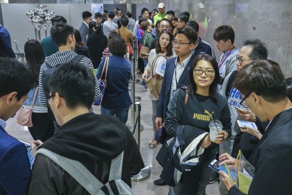 Potential buyers queuing up to bid for Wheelock’s Malibu apartments at Lohas Park in Tseung Kwan O on March 17, 2018. As many as 15 buyers registered for every unit that was available for sale. Photo: SCMP / Dickson Lee
