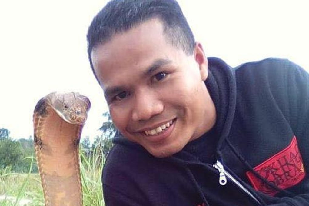 Malaysian firefighter Abu Zarin Hussin was known as the 'snake whisperer'. He died on Friday after being bitten by a cobra. Photo: Facebook