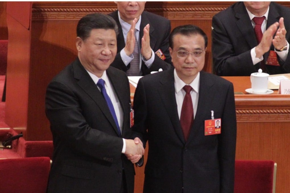 Premier Li Keqiang (right) shakes hands with President Xi Jinping at the Great Hall of the People in Beijing on Sunday after his government position was confirmed for another five years. Photo: Simon Song